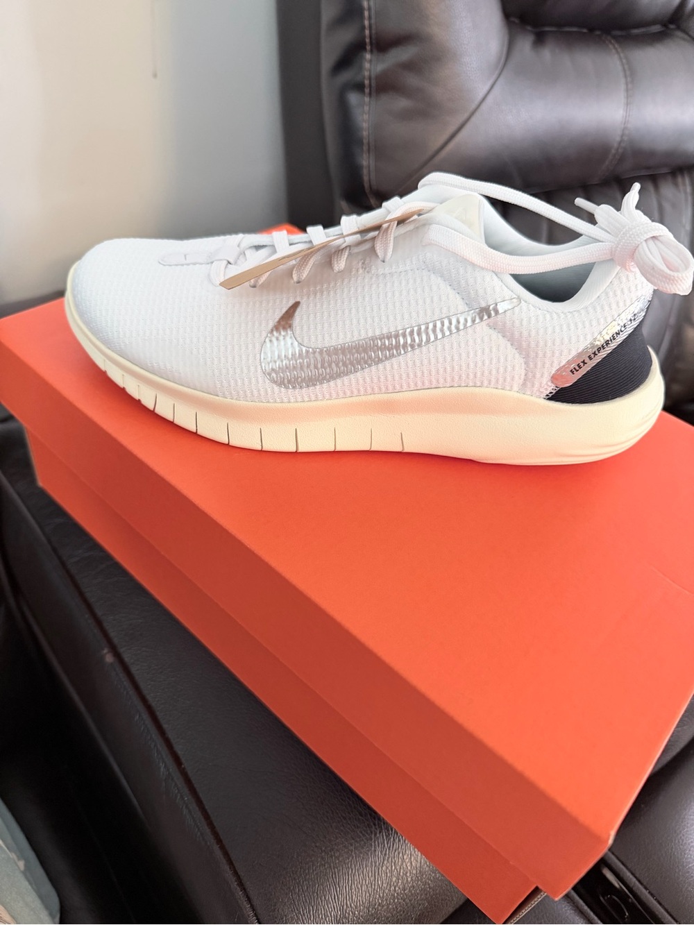 Nike Women's White Sneakers with Silver Swoosh and Black Heel Accent
